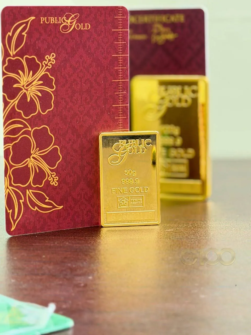 Gold certificate merah Public Gold bersama gold bar 50 gram 999.9 fine gold sebagai simpanan kekayaan jangka panjang